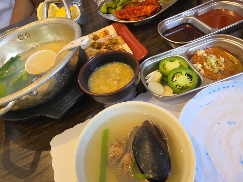 Shared table with sashimi and side dishes.